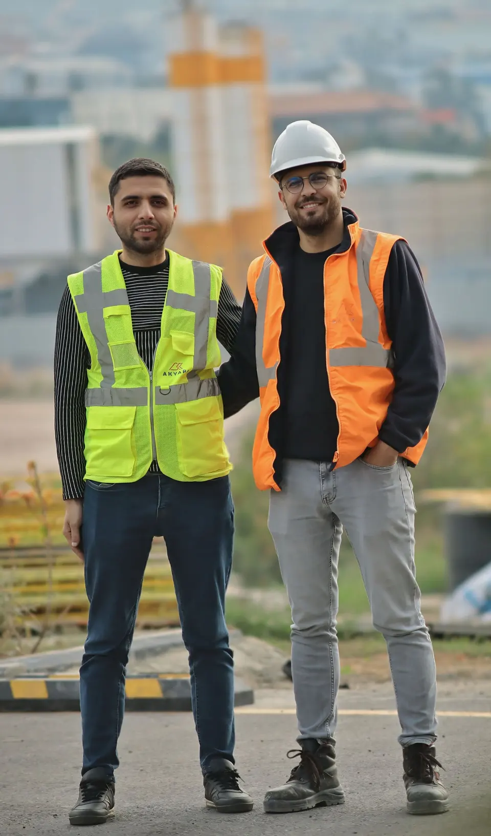 Two team members in high-visibility safety vests on site