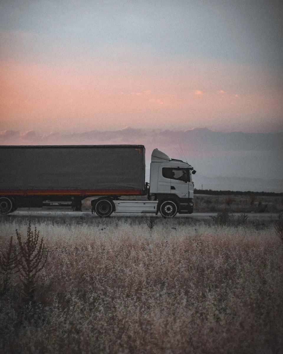 Transport truck on the road at dusk
